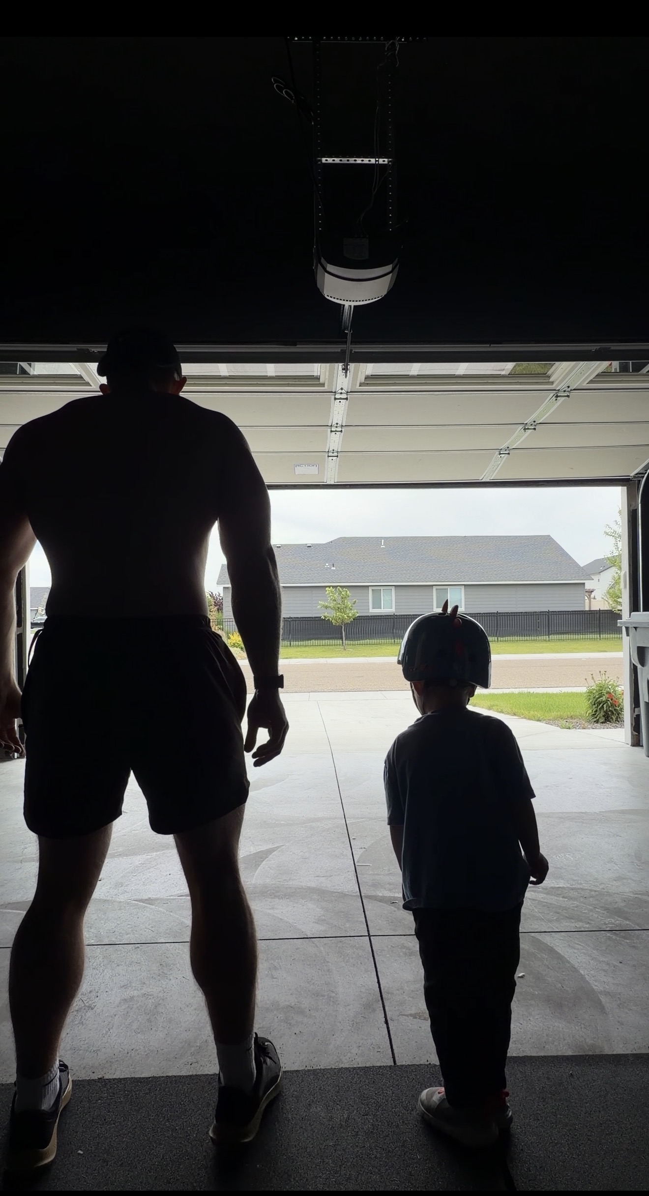 Austin and his son looking out the garage